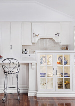 Hamptons Traditional kitchen in The Vines with white cabinetry and display cabinet with blue and white china.
