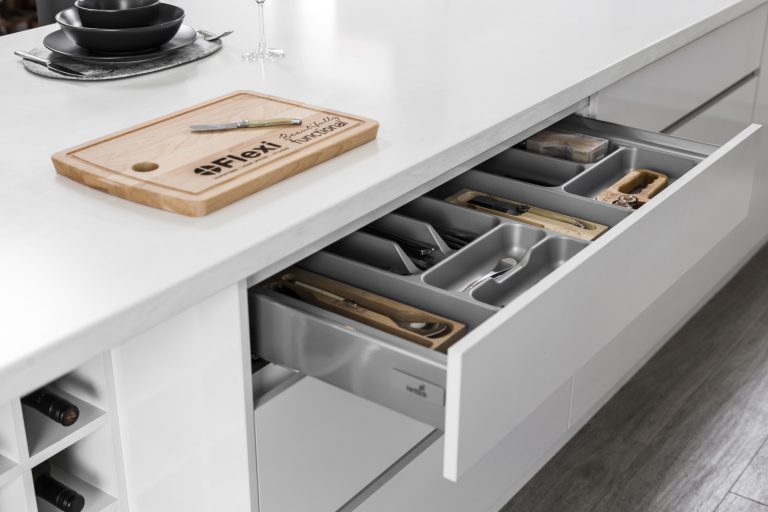 Modern kitchen design in Subiaco, Perth. Open drawer with cutlery organizer and Flexi cutting board on white countertop. Renovations by A29V5222.