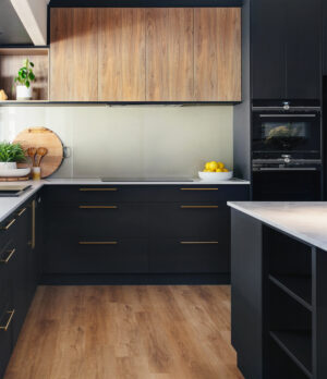 Industrial chic kitchen in Maida Vale with black cabinets, wood accents, and modern appliances. Stylish interior design.