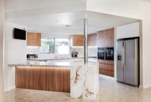 Modern organic glamour kitchen in Waterford. Features marble island, wood cabinets, and stainless steel appliances.