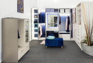 Glamorous boutique in Myaree featuring custom closet design, blue ottoman, and stylish wardrobe solutions.