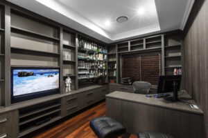 Rivervale sleek home office with custom built-in shelves, desk, and bar area. Sophisticated design. A29V7112-1024x683